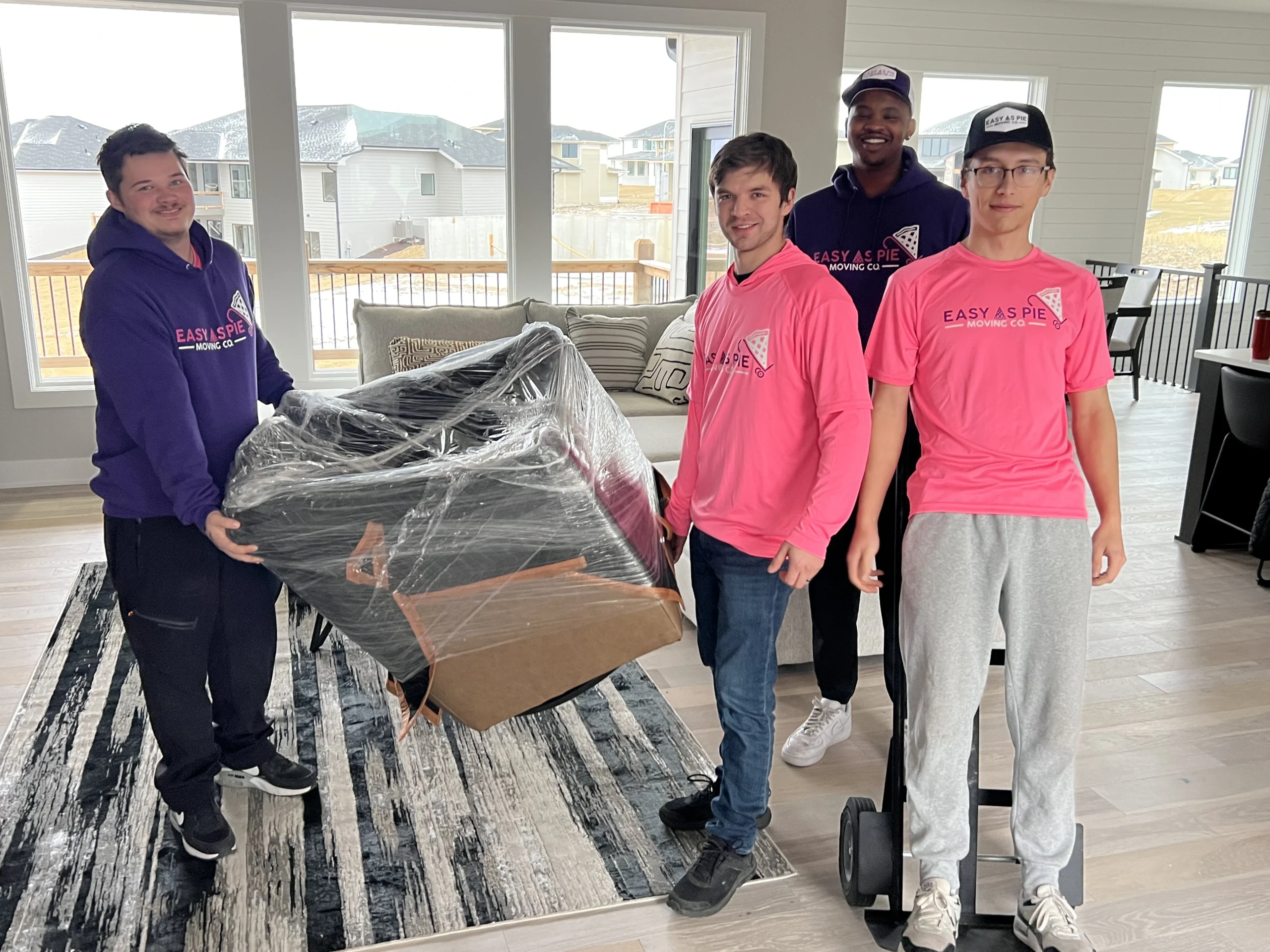 Omaha Movers – Easy As Pie Moving Co Team at Work Easy As Pie Moving Co team carefully moving furniture in Omaha home