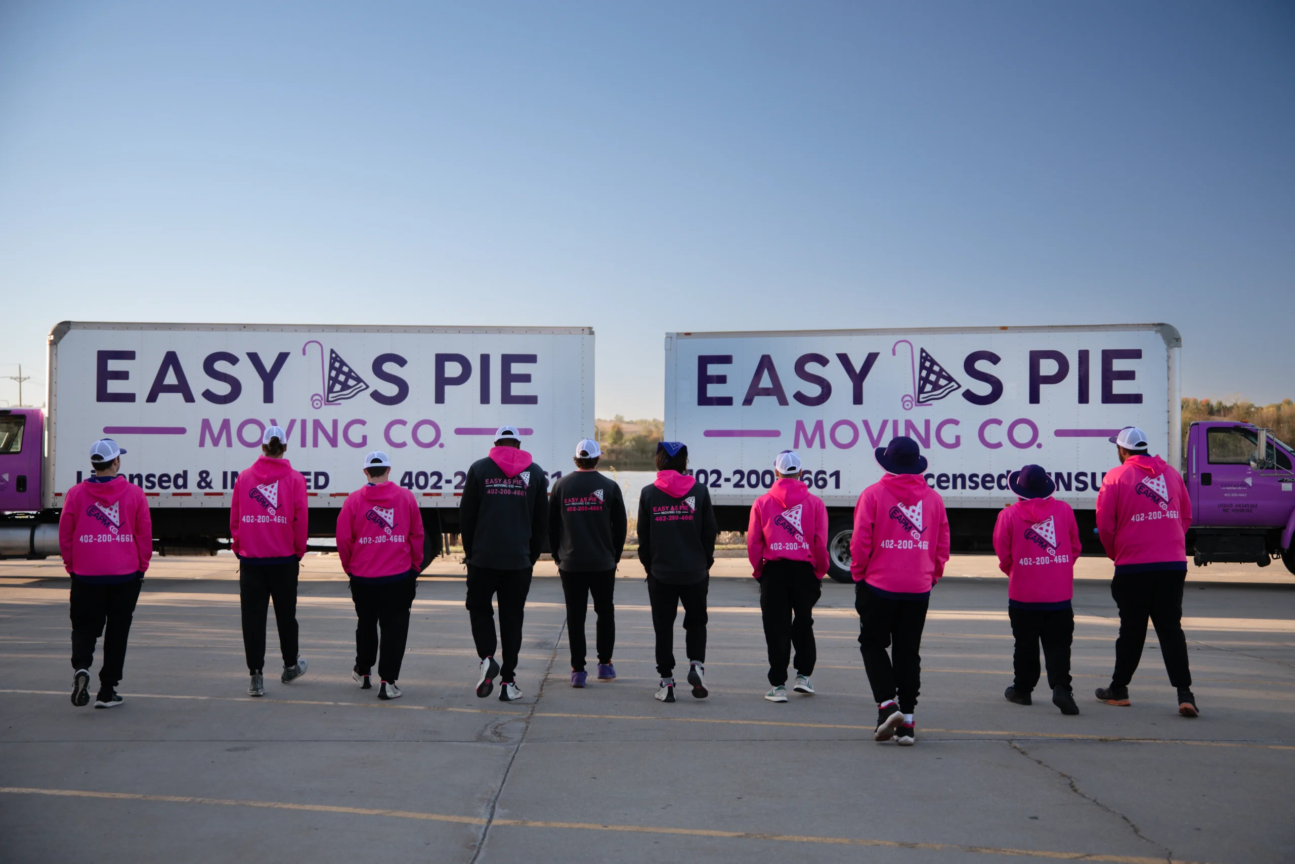 Easy As Pie Moving Co. crew in front of their moving trucks
