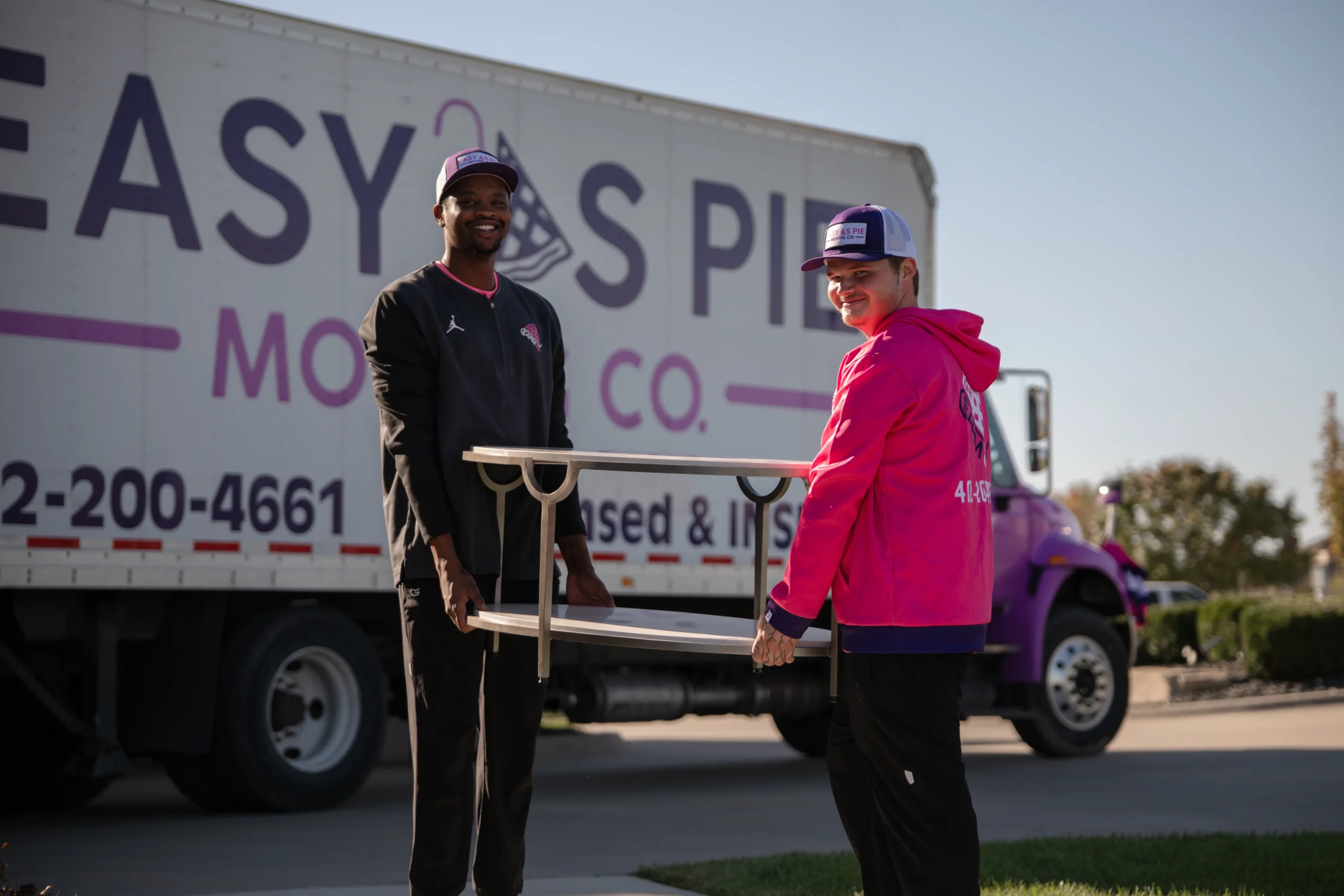 Easy As Pie movers with a dolly next to the moving truck