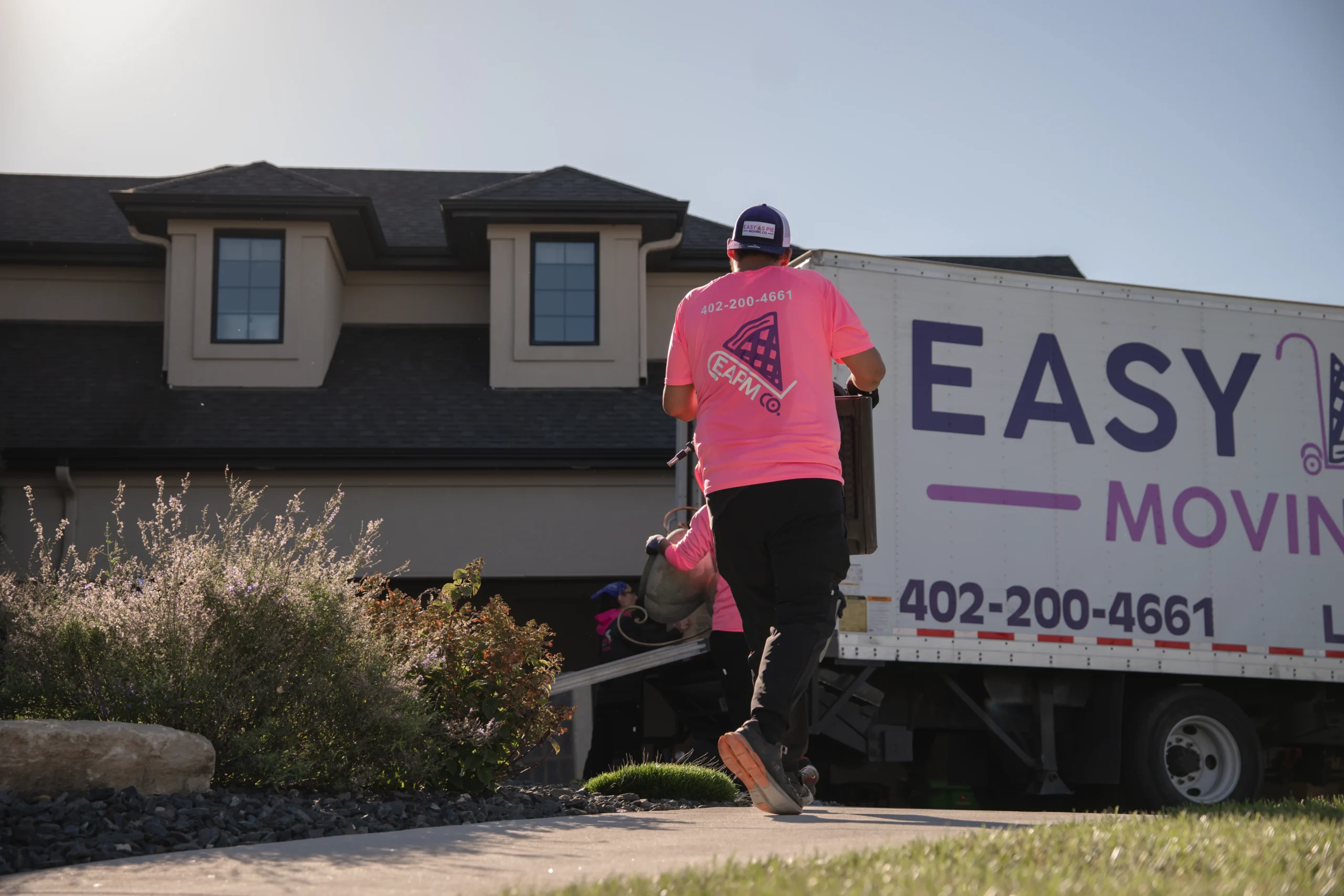 Easy As Pie mover walking a dolly to the moving truck