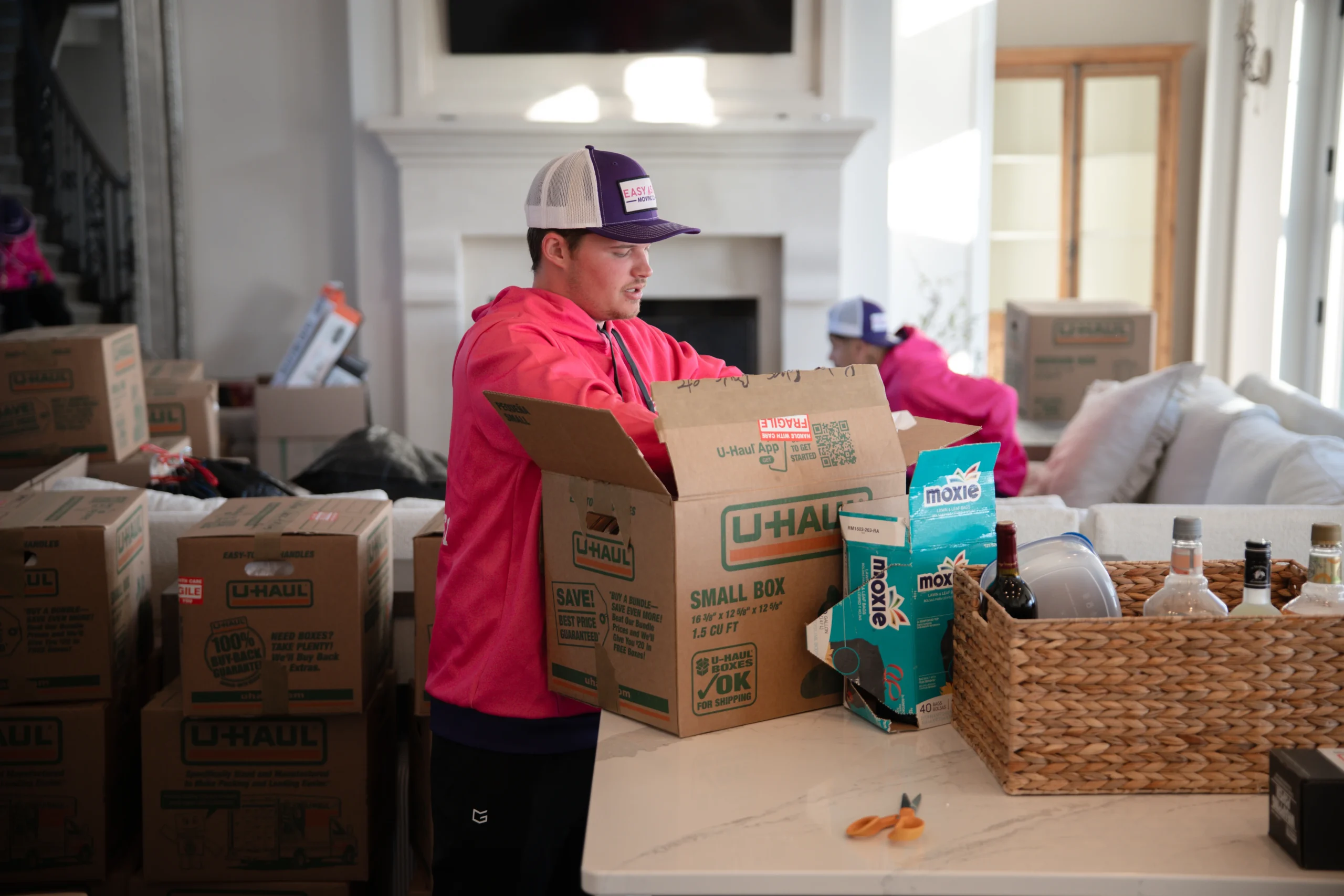 Easy As Pie movers packing boxes in a living room