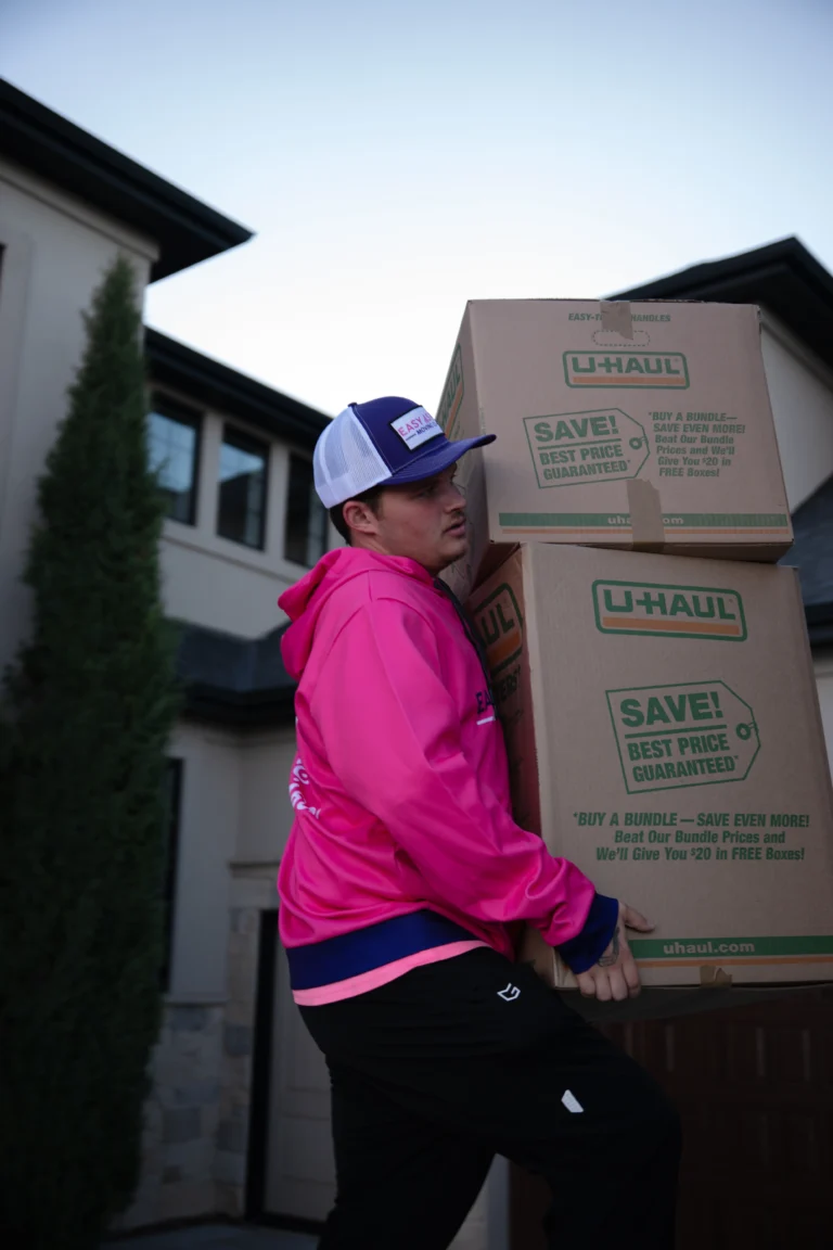 Easy As Pie mover carrying moving boxes into a home
