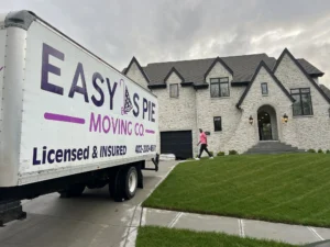 Easy As Pie Moving Co. truck marked Licensed and Insured parked outside an Omaha home