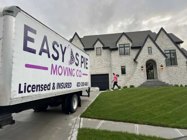 Easy As Pie Moving Co. truck marked Licensed and Insured parked outside an Omaha home