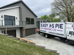 Easy As Pie Moving Co. truck in the driveway of a modern home