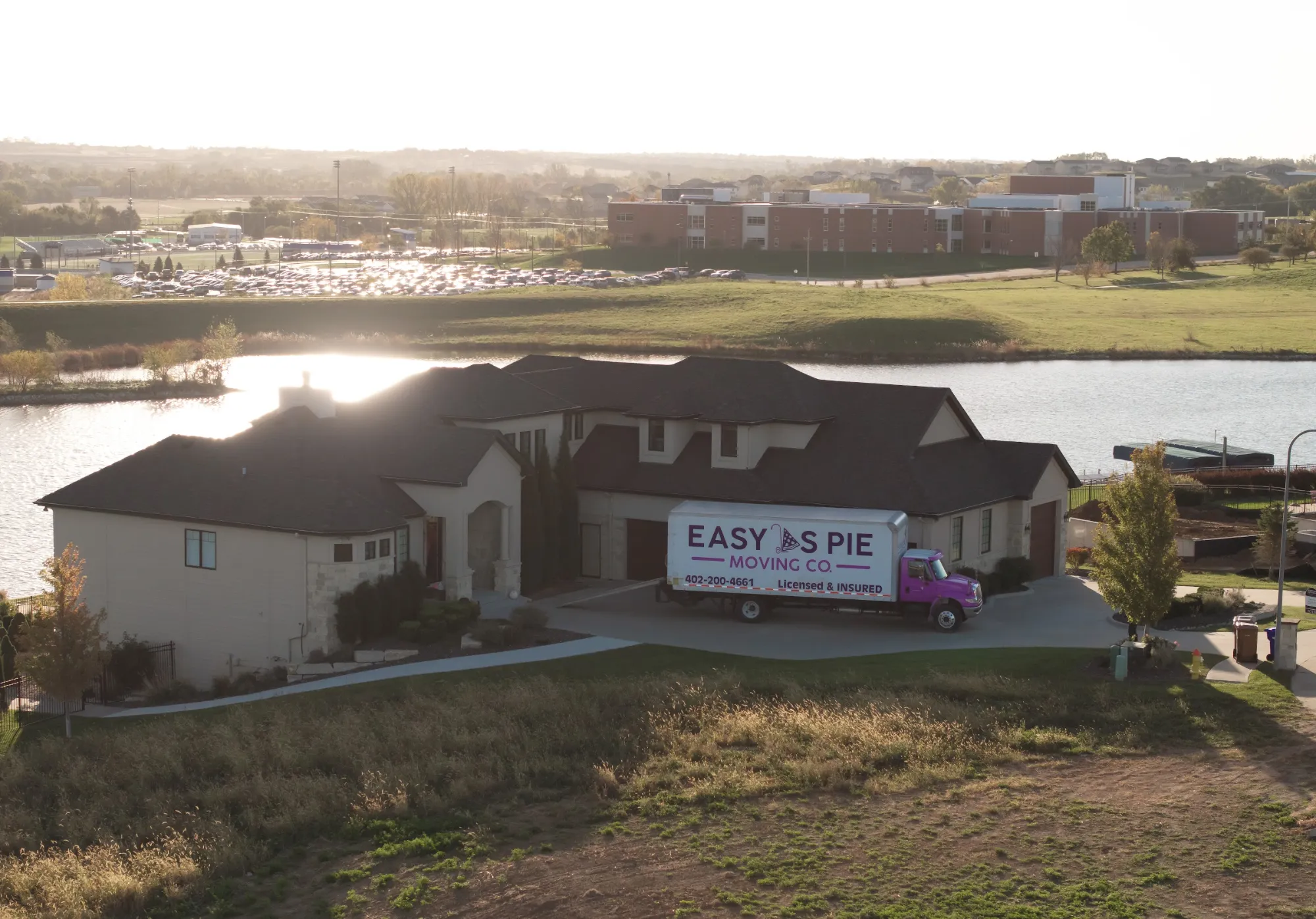Aerial view of an Easy As Pie moving truck at a lakefront home