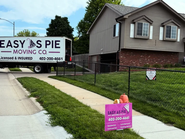 Easy As Pie moving truck outside a suburban home with a company yard sign