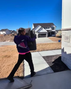 Easy As Pie mover carrying furniture out of a new home on moving day