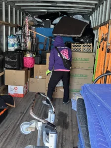 Easy As Pie mover loading boxes and furniture into a packed moving truck