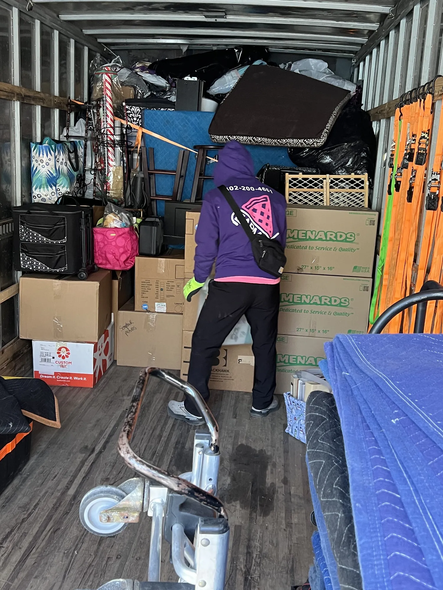 Easy As Pie mover loading boxes and furniture into a packed moving truck