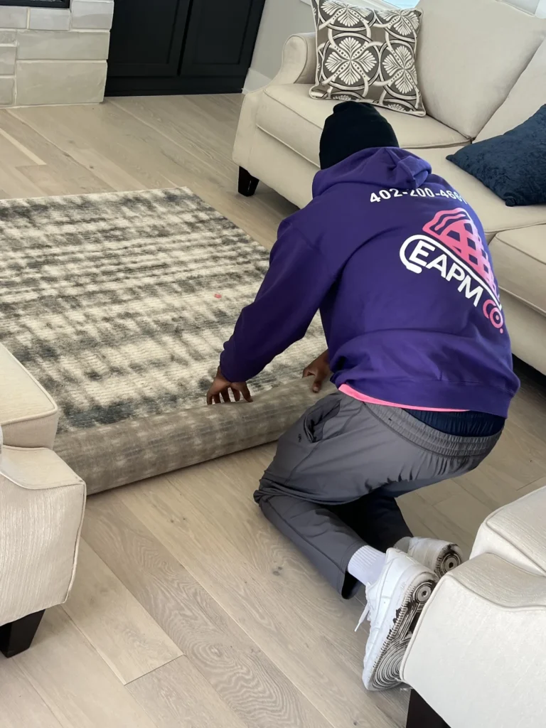 Easy As Pie mover laying out a rug in a staged home