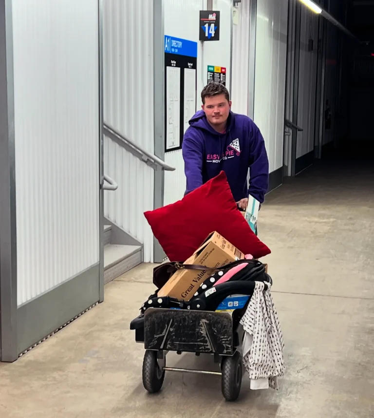Easy As Pie mover pushing a loaded cart down a building hallway