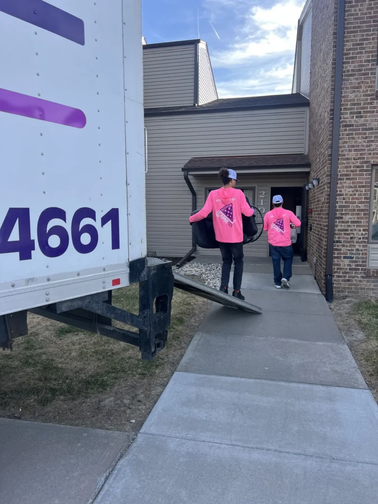 Easy As Pie movers walking from the truck to an apartment entrance