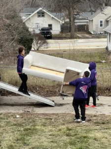 Easy As Pie movers carrying a couch down a truck ramp