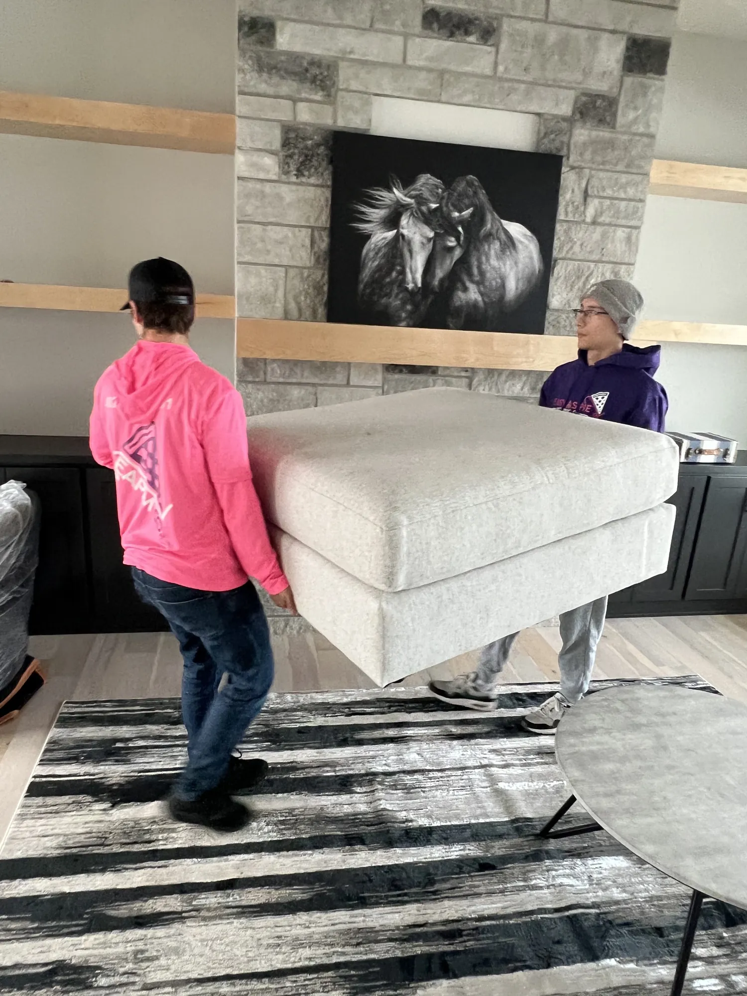 Easy As Pie movers carrying an ottoman into a staged living room