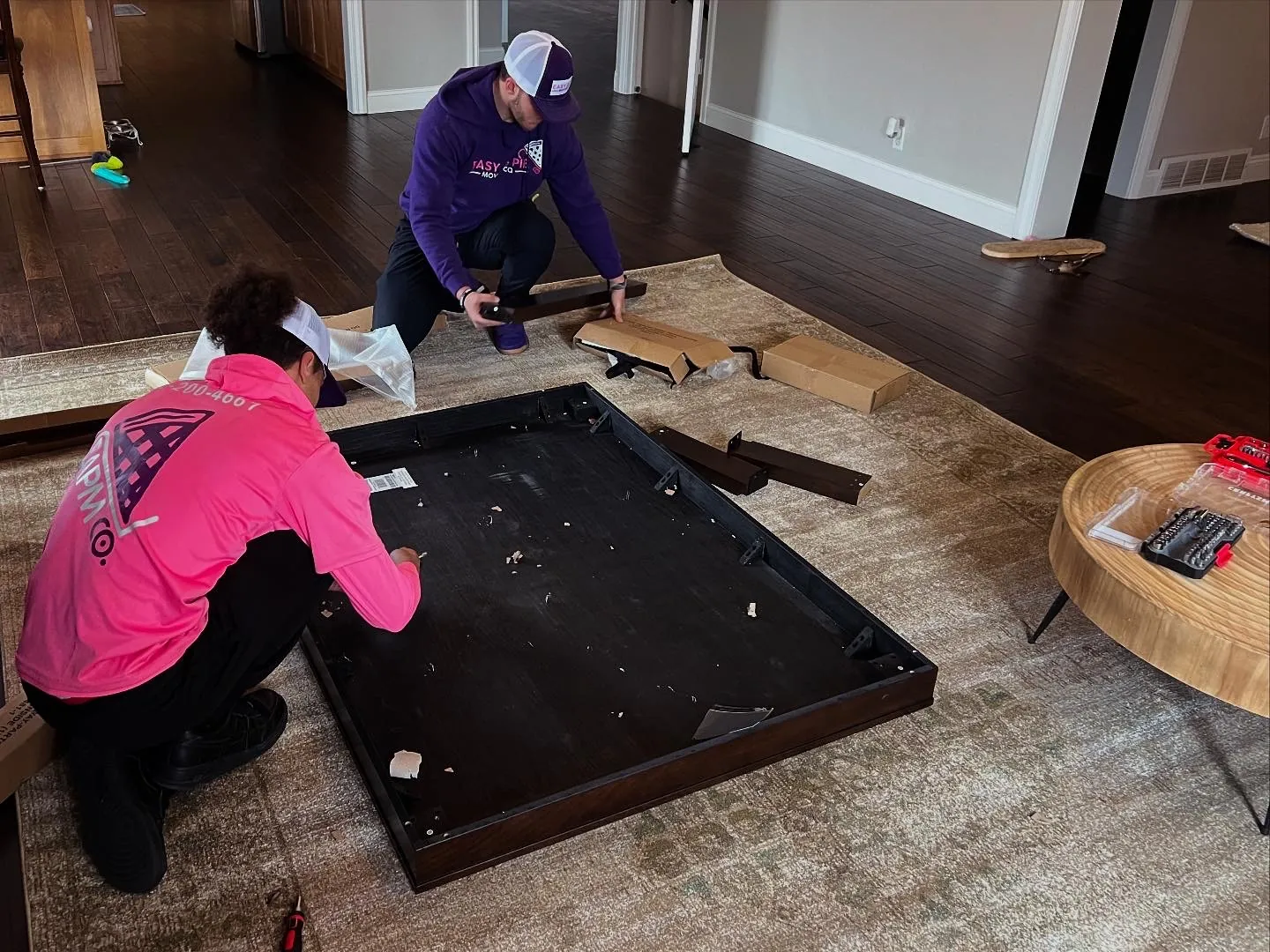 Easy As Pie movers disassembling a bed frame before a move