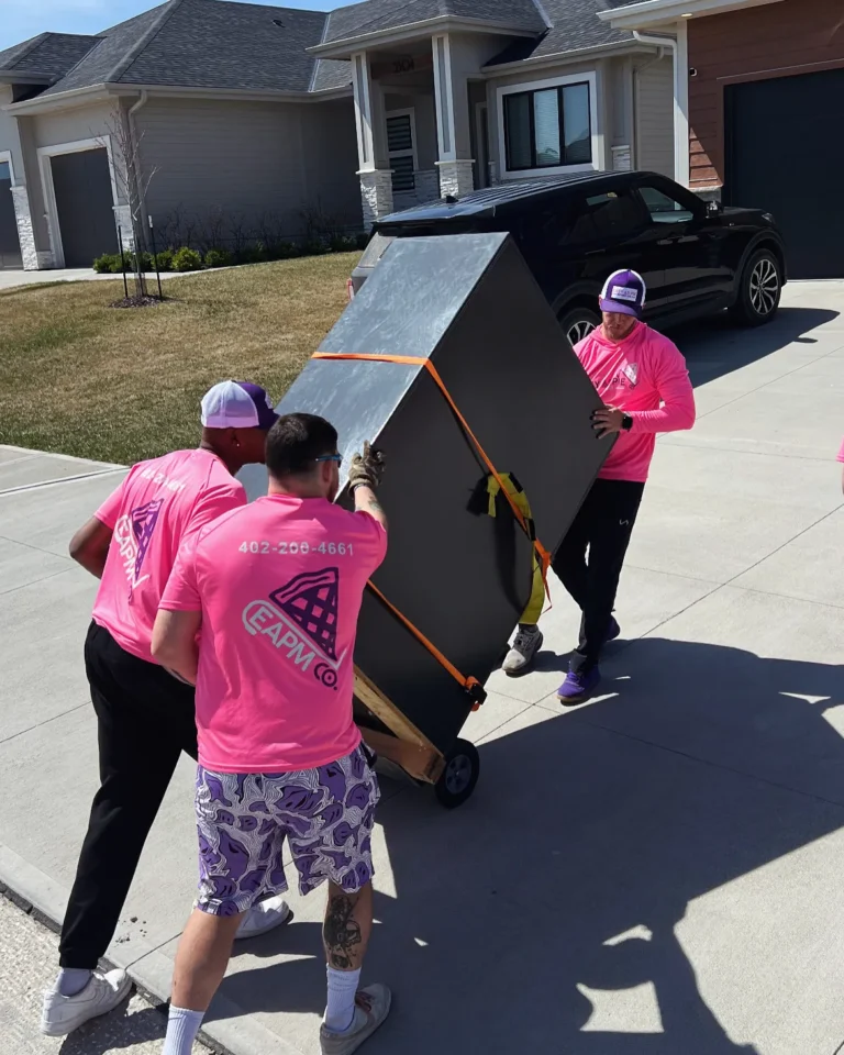 Easy As Pie movers wheeling a dresser on a dolly during a local move