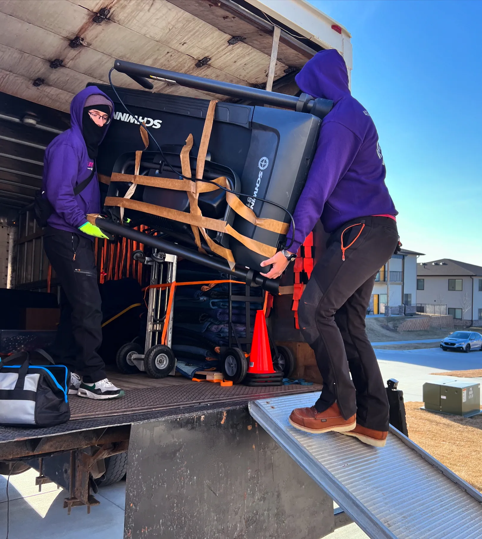 Easy As Pie movers loading strapped furniture onto a moving truck
