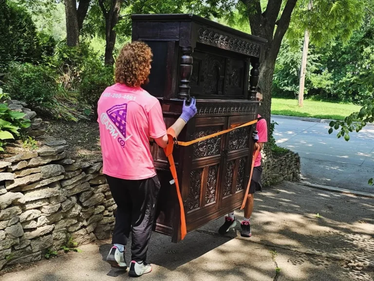 Easy As Pie mover using lifting straps to move a heavy antique cabinet