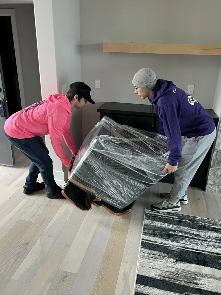 Easy As Pie movers wrapping a table in plastic wrap