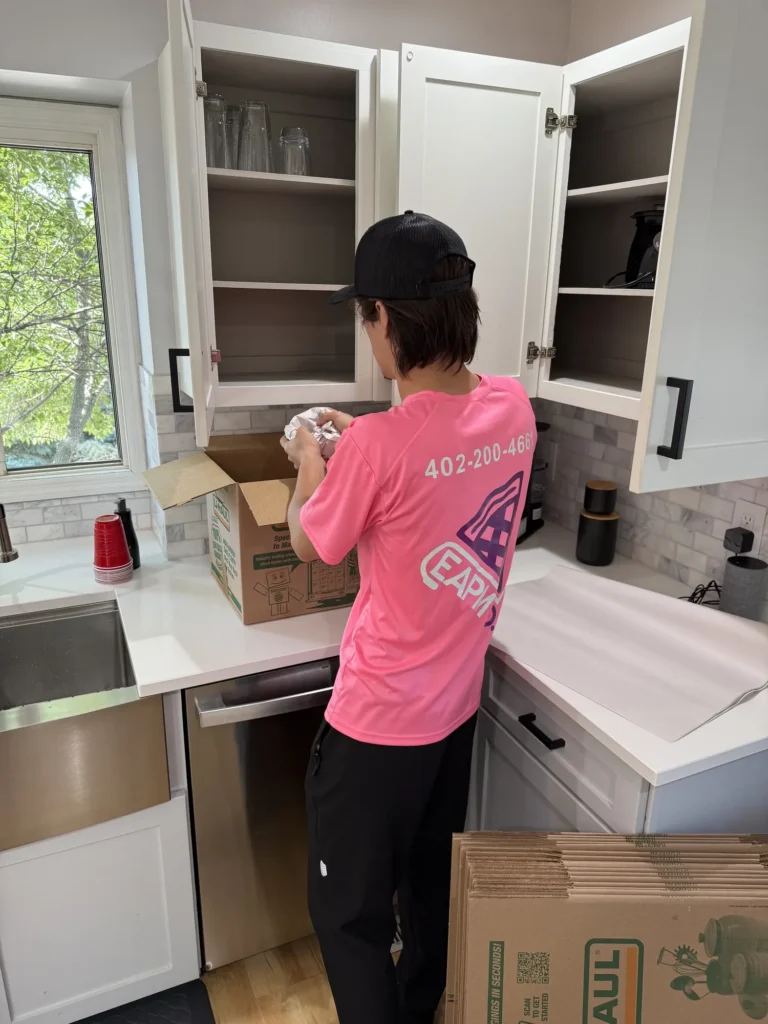 Easy As Pie mover packing kitchen cabinets into moving boxes