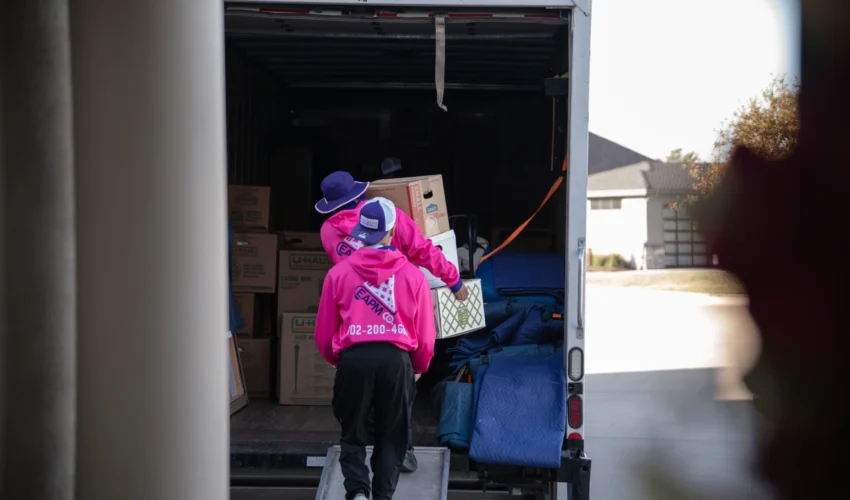Professional local apartment movers omaha securing items in moving truck near Midtown complex. Apartment Movers Omaha