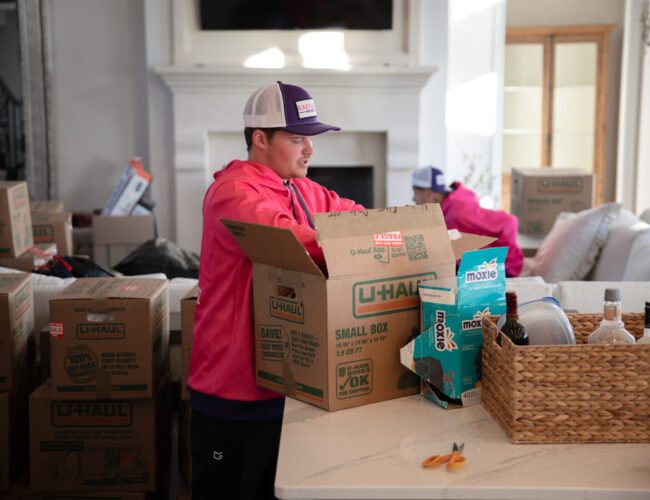 Team carefully packing living room items